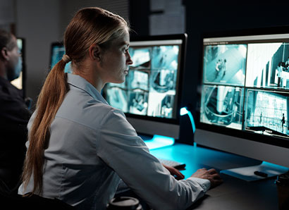 Woman monitoring security camera feed