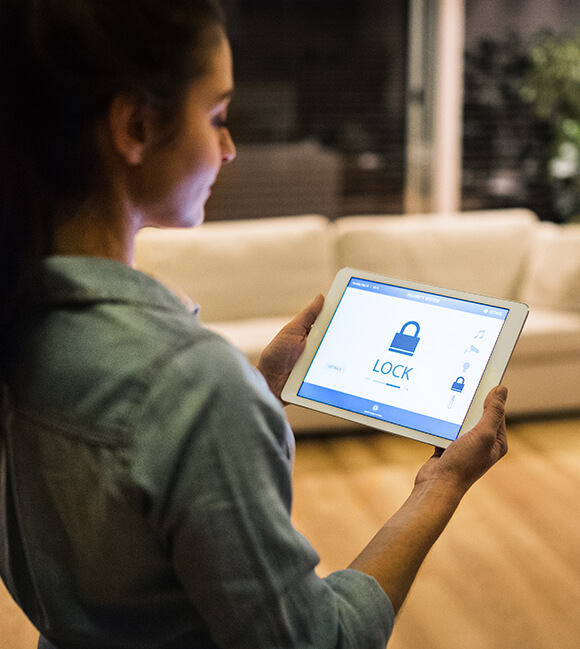 Woman holding a tablet with a lock on the screen